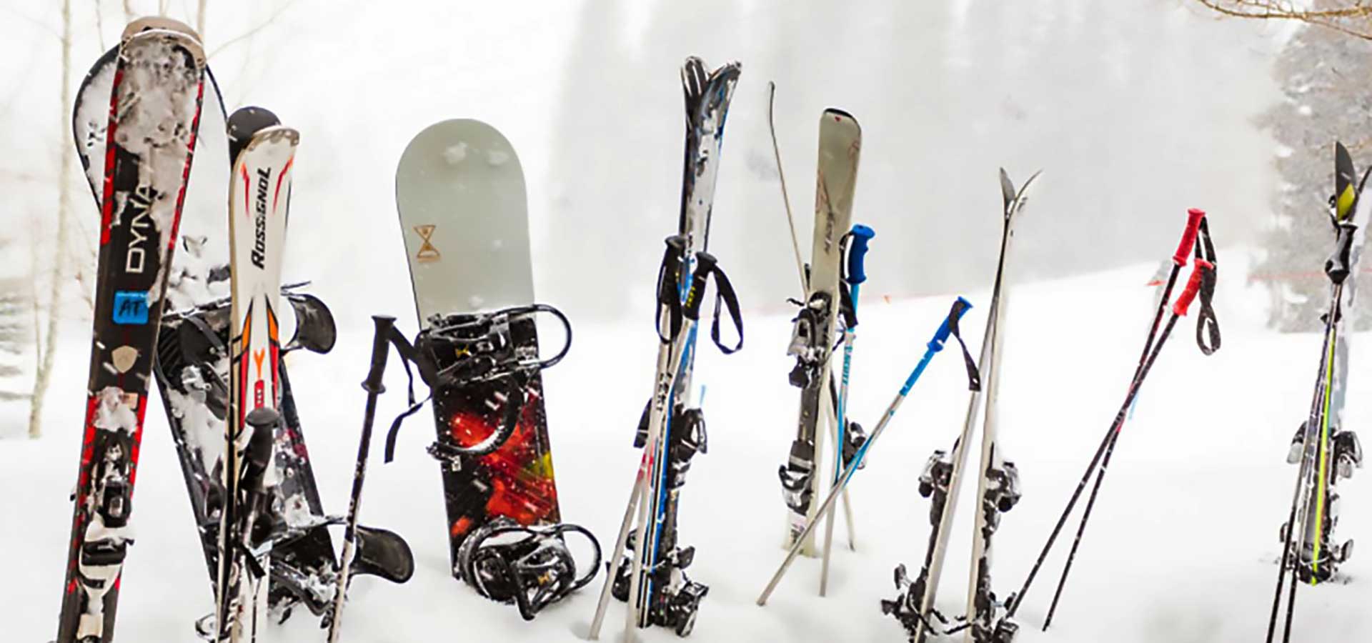 Snowboards and skis in the snow