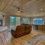 Open-concept living room and kitchen in vacation rental with great mountain views by A River Runs Thru It