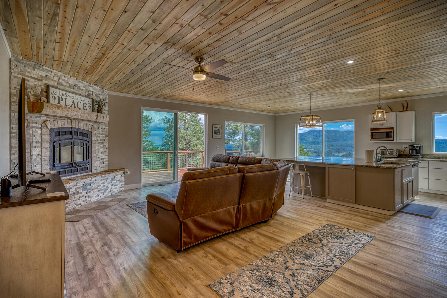 Open-concept living room and kitchen in vacation rental with great mountain views by A River Runs Thru It