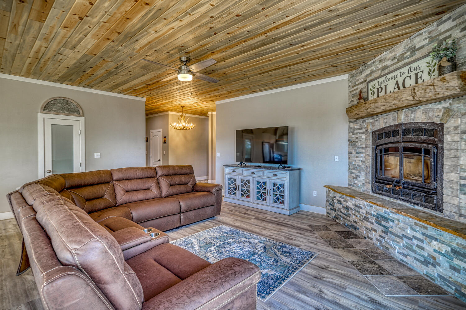 Living room and fireplace in vacation home with mountain views by A River Runs Thru It
