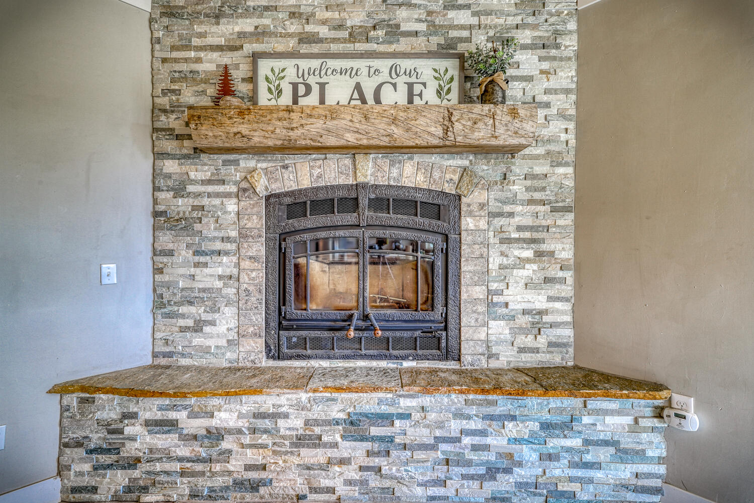 Beautiful stone fireplace in vacation home with mountain views by A River Runs Thru It