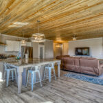 Open-concept kitchen and living room in vacation rental with great mountain views by A River Runs Thru It