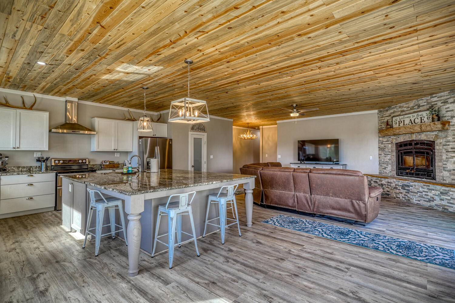 Open-concept kitchen and living room in vacation rental with great mountain views by A River Runs Thru It