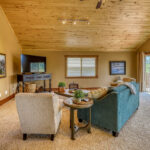Large family room with sofas, table seating, and flat-screen TV in Eagle's View