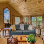 Large family room with sofas, table seating, and flat-screen TV in Eagle's View with great mountain view