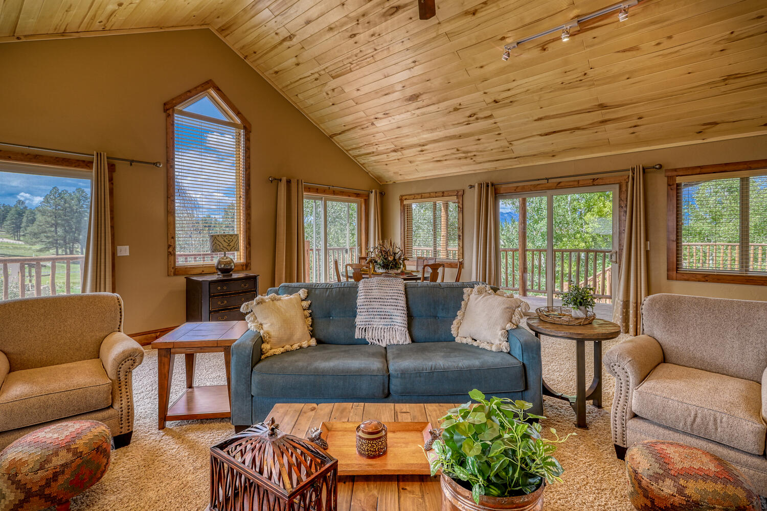 Large family room with sofas, table seating, and flat-screen TV in Eagle's View with great mountain view