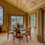 Large family room with sofas, table seating, and flat-screen TV in Eagle's View with mountain views