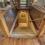 Steps leading to bottom level, with bedroom and entertainment area, of Eagle's View vacation home in Pagosa