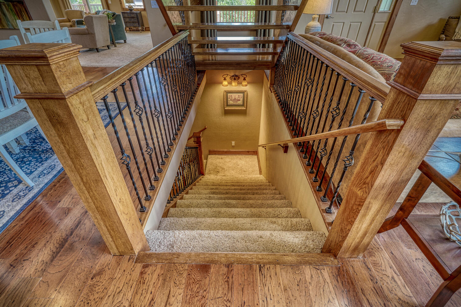 Steps leading to bottom level, with bedroom and entertainment area, of Eagle's View vacation home in Pagosa