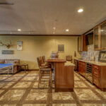 Bottom-level entertainment room with ping pong table and bar area with seating at Eagle's View vacation home